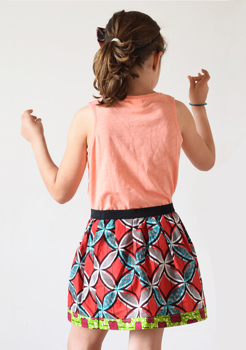 Cora & Lea-girl-New Order skirt. African Wax-Print, red, blue and white geometric prints. 