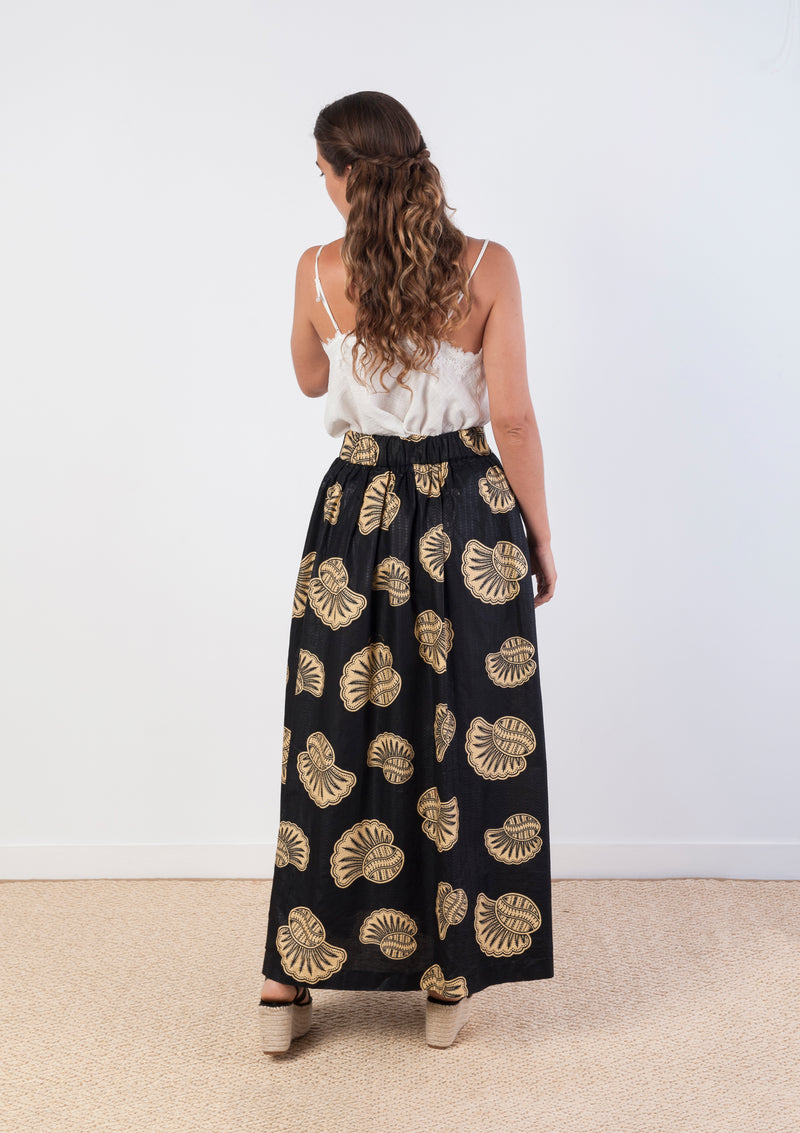 Cora & Lea-woman-long skirt Suzanne. African Wax-Print, black print and cream with shell motifs. 