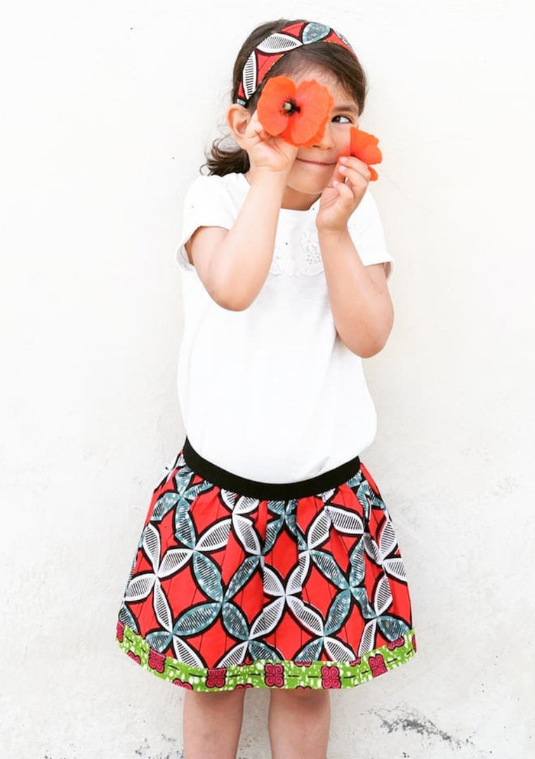 Cora & Lea-girl-New Order skirt. African Wax-Print, red, blue and white geometric prints. 