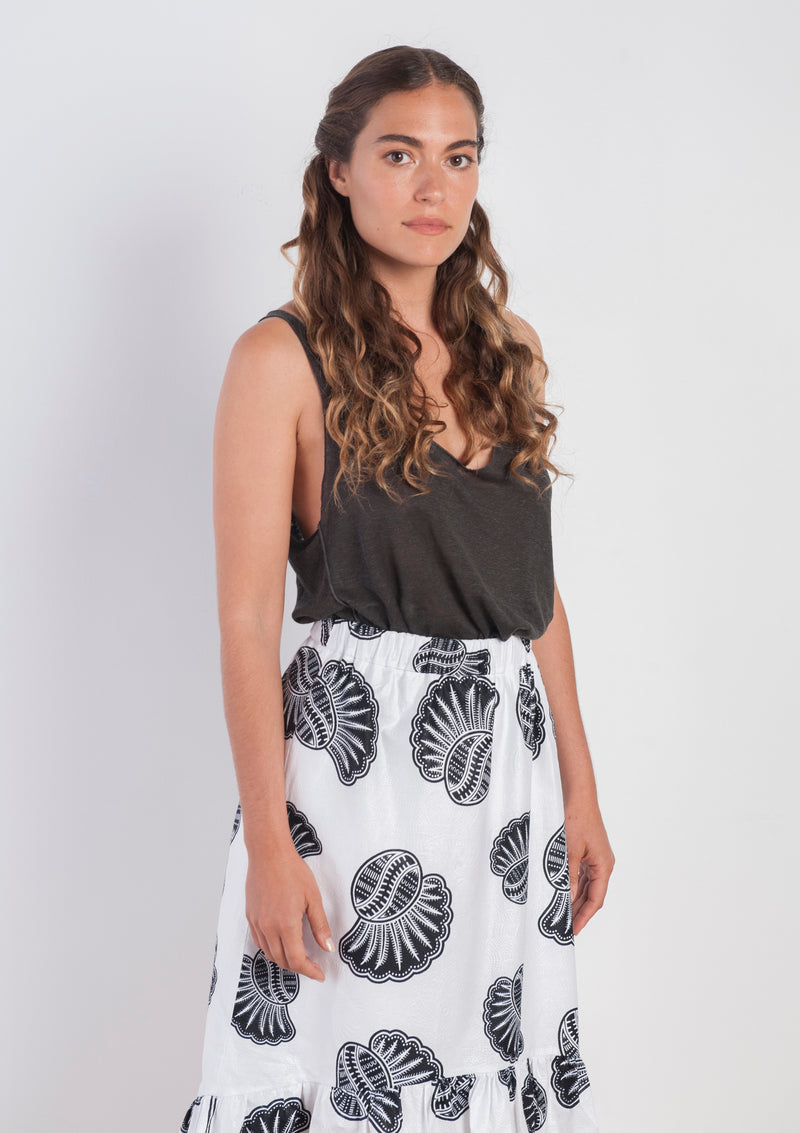 Cora & Lea-woman-asymmetric Jagger skirt. African Wax-Print, black and white prints with sea shells. 